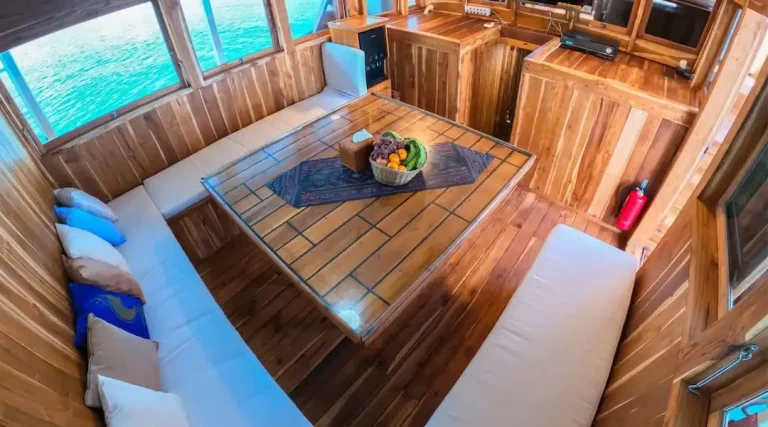 The indoor dining area aboard Malca Voyages, laid for a meal