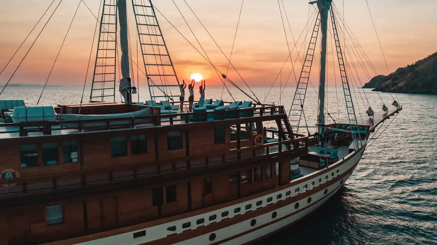 Guests on the open deck of a Komodo liveaboard