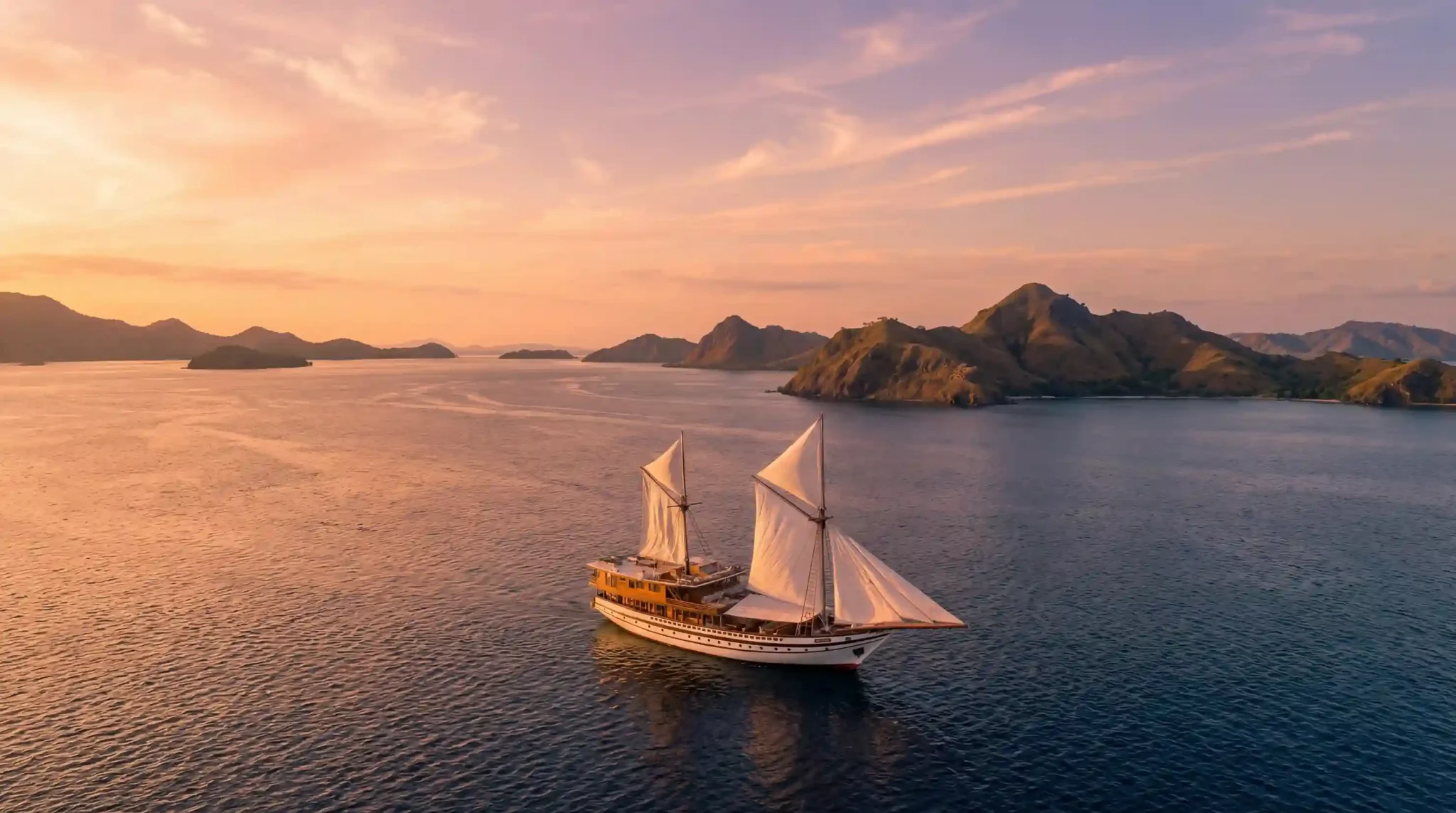 A single chartered phinisi alone off a Komodo island